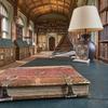 An impressive library with book stacks to either side and large desk in the foreground