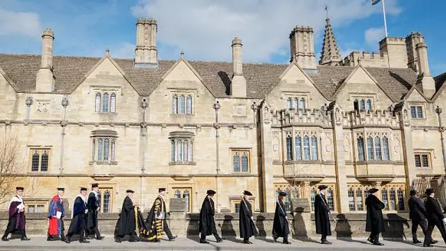 The procession walks towards Magdalen College after the Chancellor's honorary degree ceremony