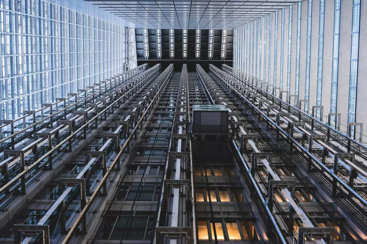 Black metal framework covering a glass wall creates a series of squares and rectangles, viewed from below